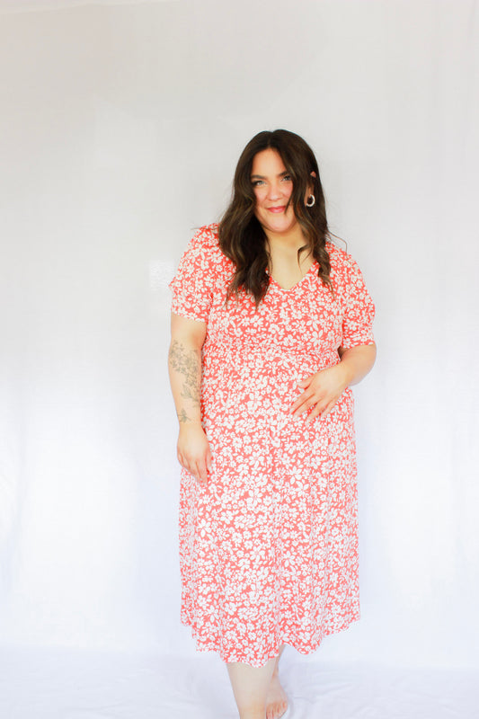Bright red-orange with white floral midi length dress with subtle puff sleeves and v neckline