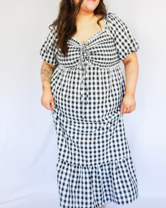 Black and white gingham maxi dress with puff short sleeves and smocked detail on chest with tieing string and tiered skirt