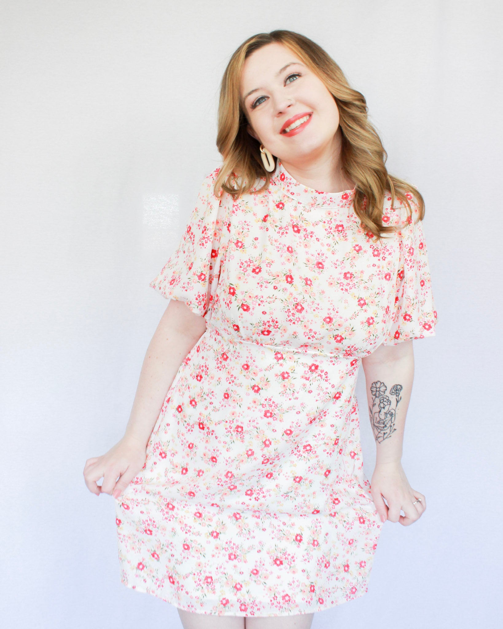 White mini floral dress with bright pink flowers, puff short sleeves, and high neckline 