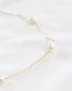 Danity small gold necklace with mini pearls attached every inch