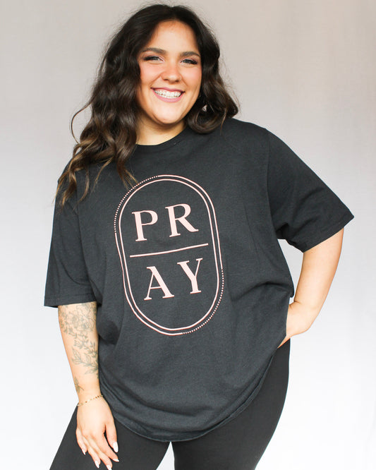 Black tshirt with Pray graphic in a dotted oval  