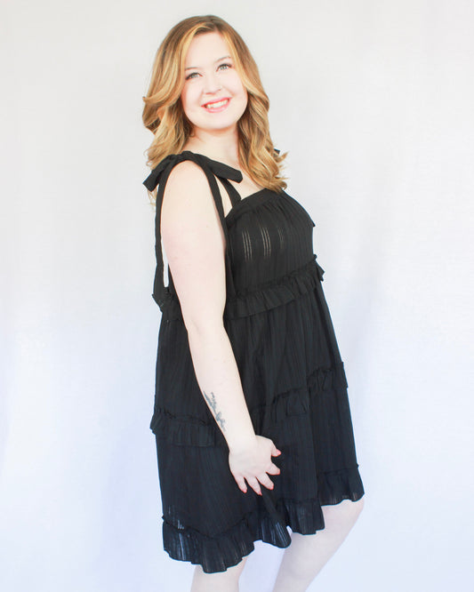 Little black mini dress with tie sleeves and tiered skirt 