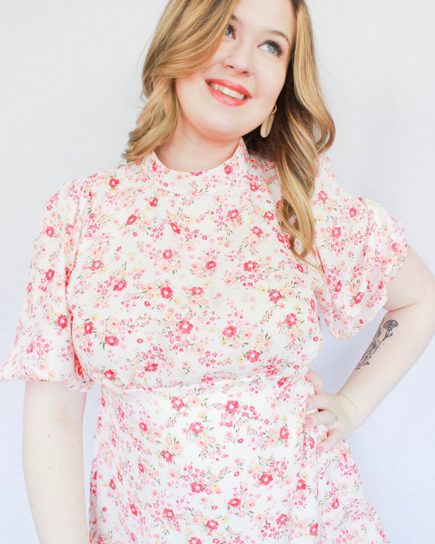 White mini floral dress with bright pink flowers, puff short sleeves, and high neckline 