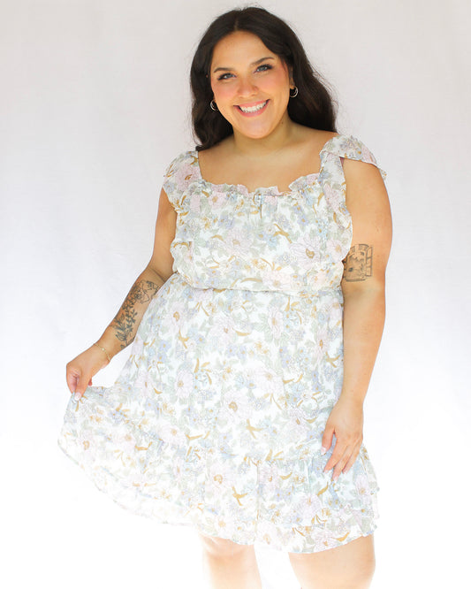 Pastel color floral mini dress with square neckline flutter sleeve and tiered skirt with waistline