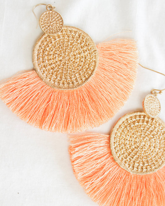 Boho statement earrings with one mini gold texture circle into a big one with orange tassel around big circle