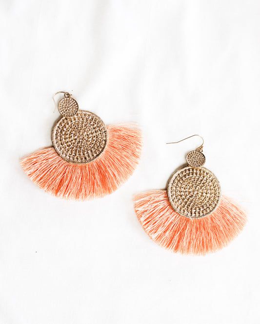 Boho statement earrings with one mini gold texture circle into a big one with orange tassel around big circle