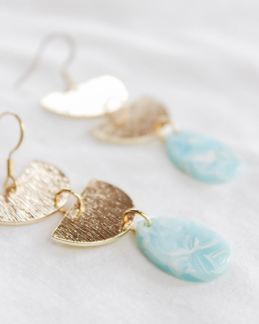 Boho gold dangle earrings with two upside down half moon chained with oval baby blue stone at the end