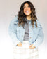 Slightly cropped light wash stretchy denim jacket with two chest pockets and two hand pockets, silver buttons