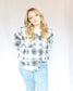 White button up long sleeve flannel with thick navy blue stripes and small peach and light blue two chest pockets side slits 