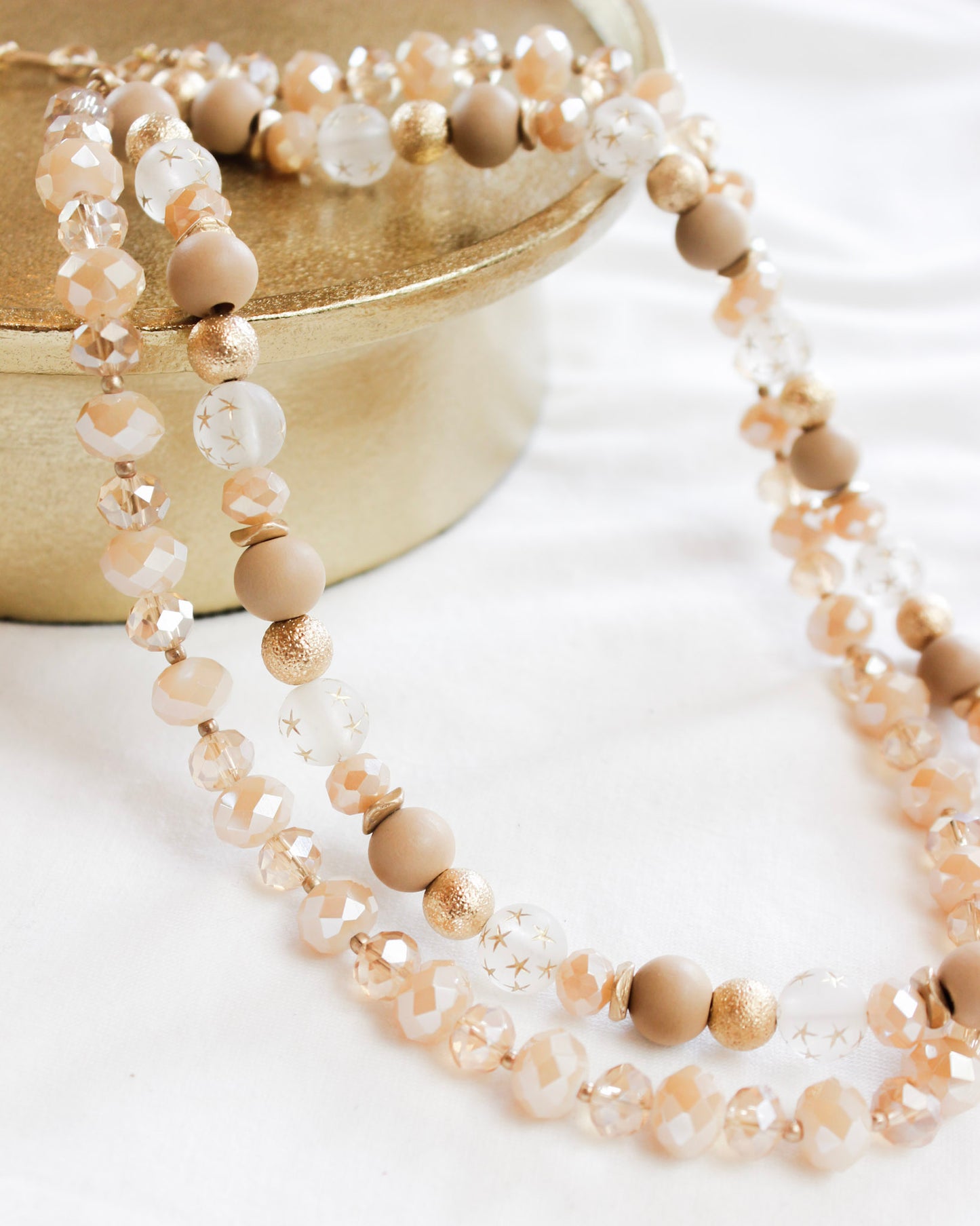 Rose gold assorted layered bead necklace with gold details and mini stars 