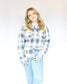 White button up long sleeve flannel with thick navy blue stripes and small peach and light blue two chest pockets side slits 