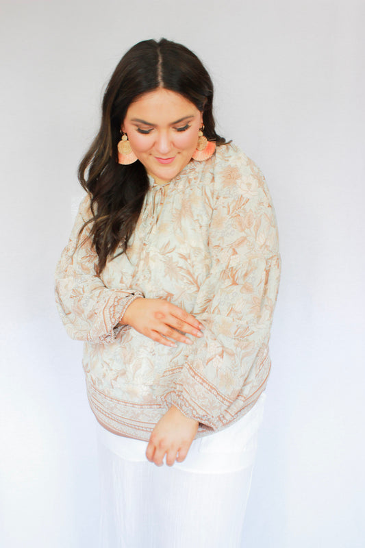 Boho style muted earth floral color blouse with tie round neckline, long balloon sleeves, sheer fabric