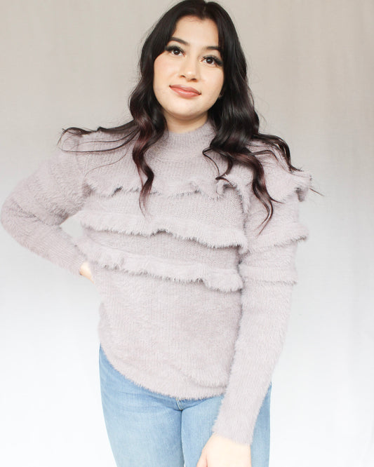 Lavender fuzzy mock neck sweater with three horizontal ruffles over chest into sleeves 