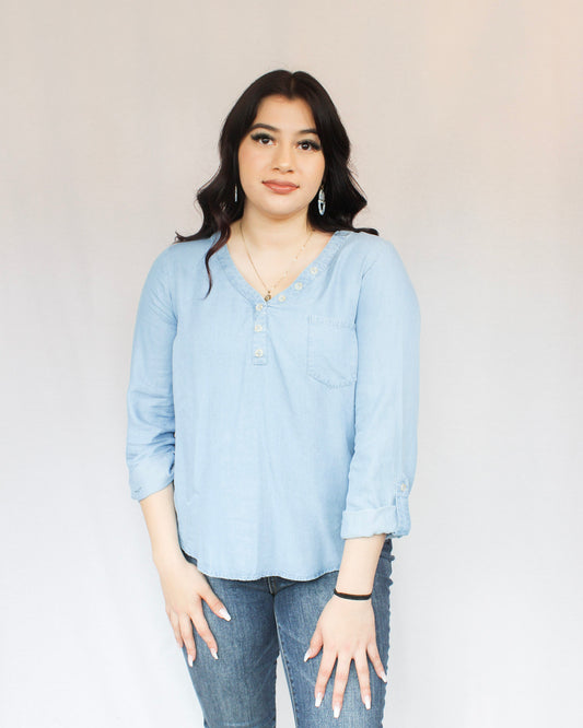 Denim chambray top with button detailing on v-neckline, full length, and roll up sleeves