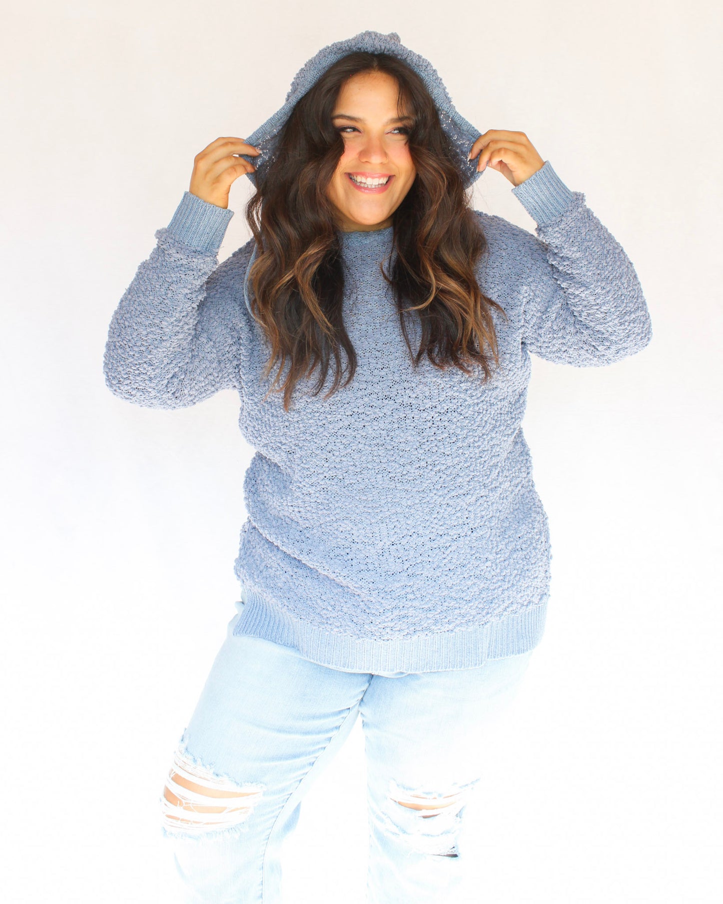 Blue fuzzy popcorn sweater with hood and long sleeves