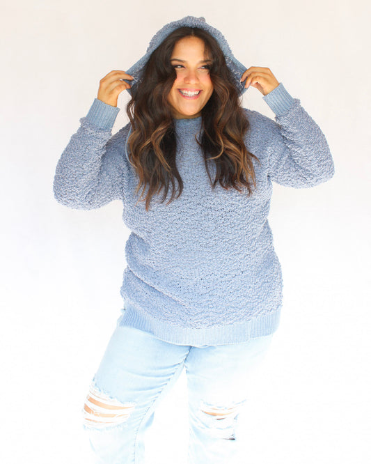 Blue fuzzy popcorn sweater with hood and long sleeves