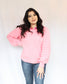 Bright pink thick sweater with ribbed hem round neck and raglan balloon sleeves paired with Judy Blue Jeans