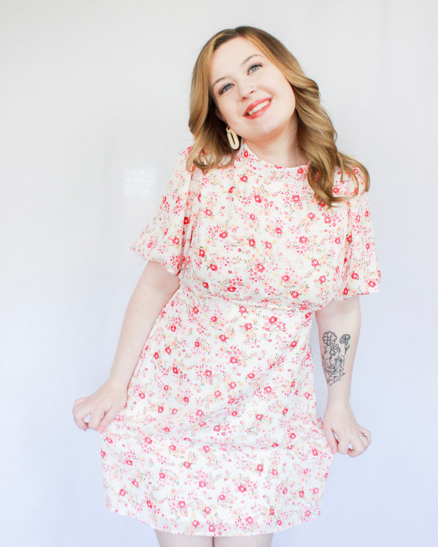 White mini floral dress with bright pink flowers, puff short sleeves, and high neckline 