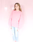 Bright pink thick sweater with ribbed hem round neck and raglan balloon sleeves paired with Judy Blue Jeans