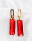 Shiny gold dangle statement earrings with rectangle red gem  