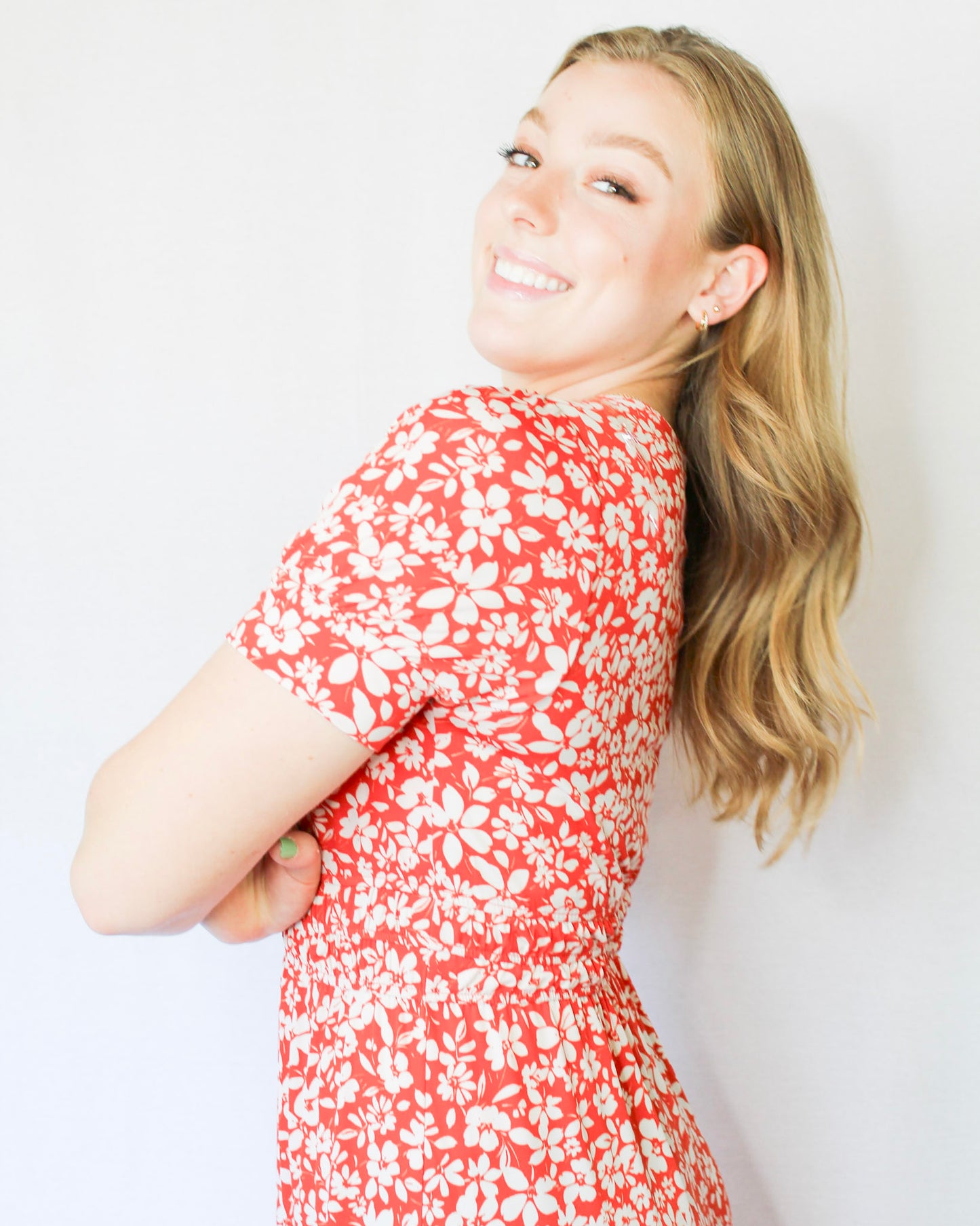 Bright red-orange with white floral midi length dress with subtle puff sleeves and v neckline