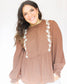 Brown long sleeve peplum long sleeve top with white floral detailing down the front sides