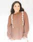 Brown long sleeve peplum long sleeve top with white floral detailing down the front sides