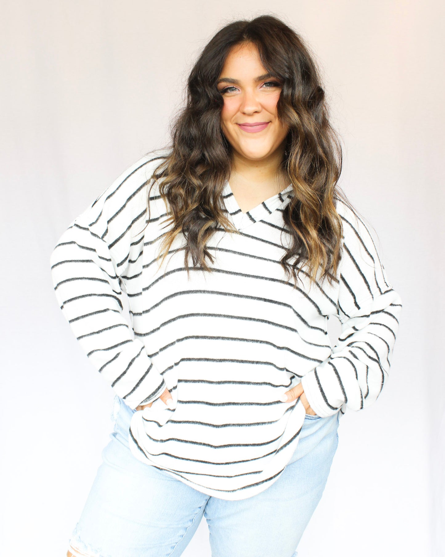 Soft white with black thin horizontal striped long sleeve top with v-neckline, full length 