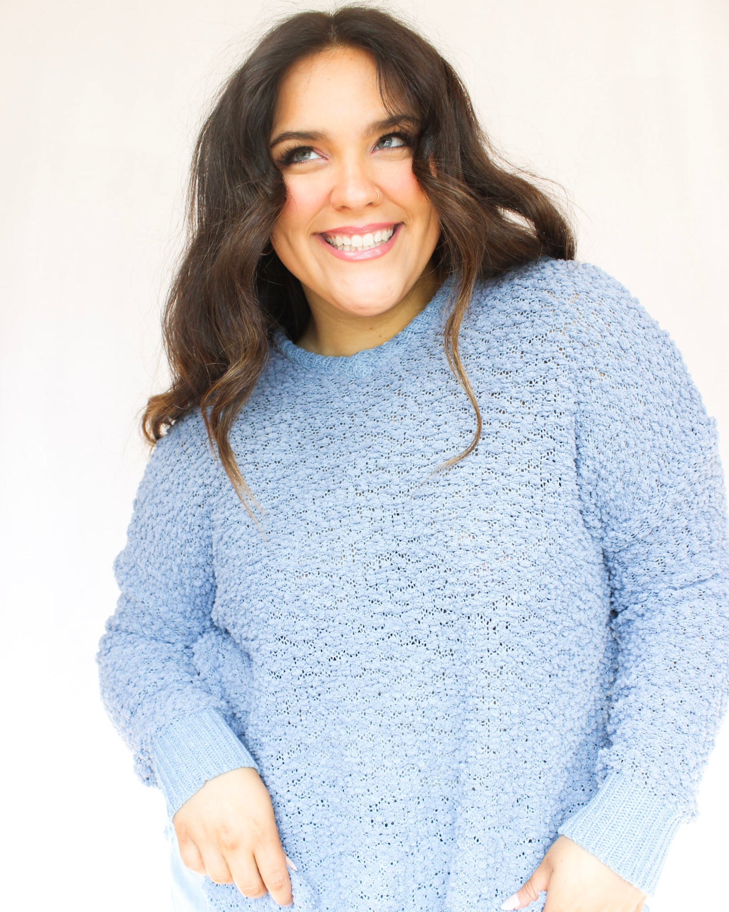 Blue fuzzy popcorn sweater with hood and long sleeves