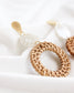 boho style statement earrings with gold accents and tortoise circle into a big wicker round circle 