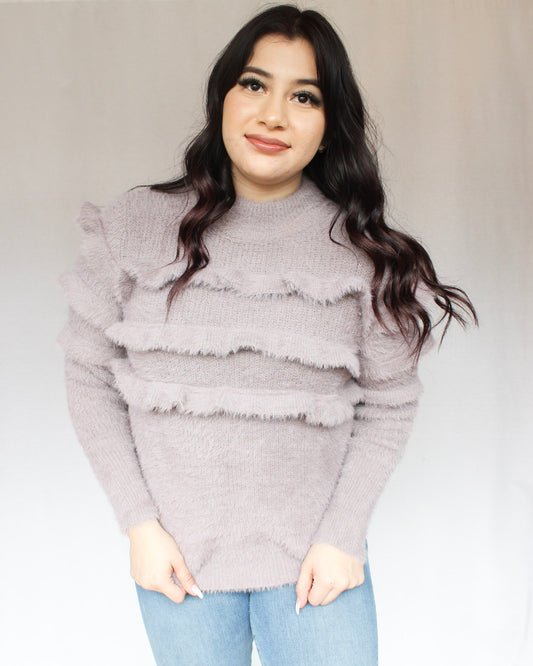 Lavender fuzzy mock neck sweater with three horizontal ruffles over chest into sleeves 