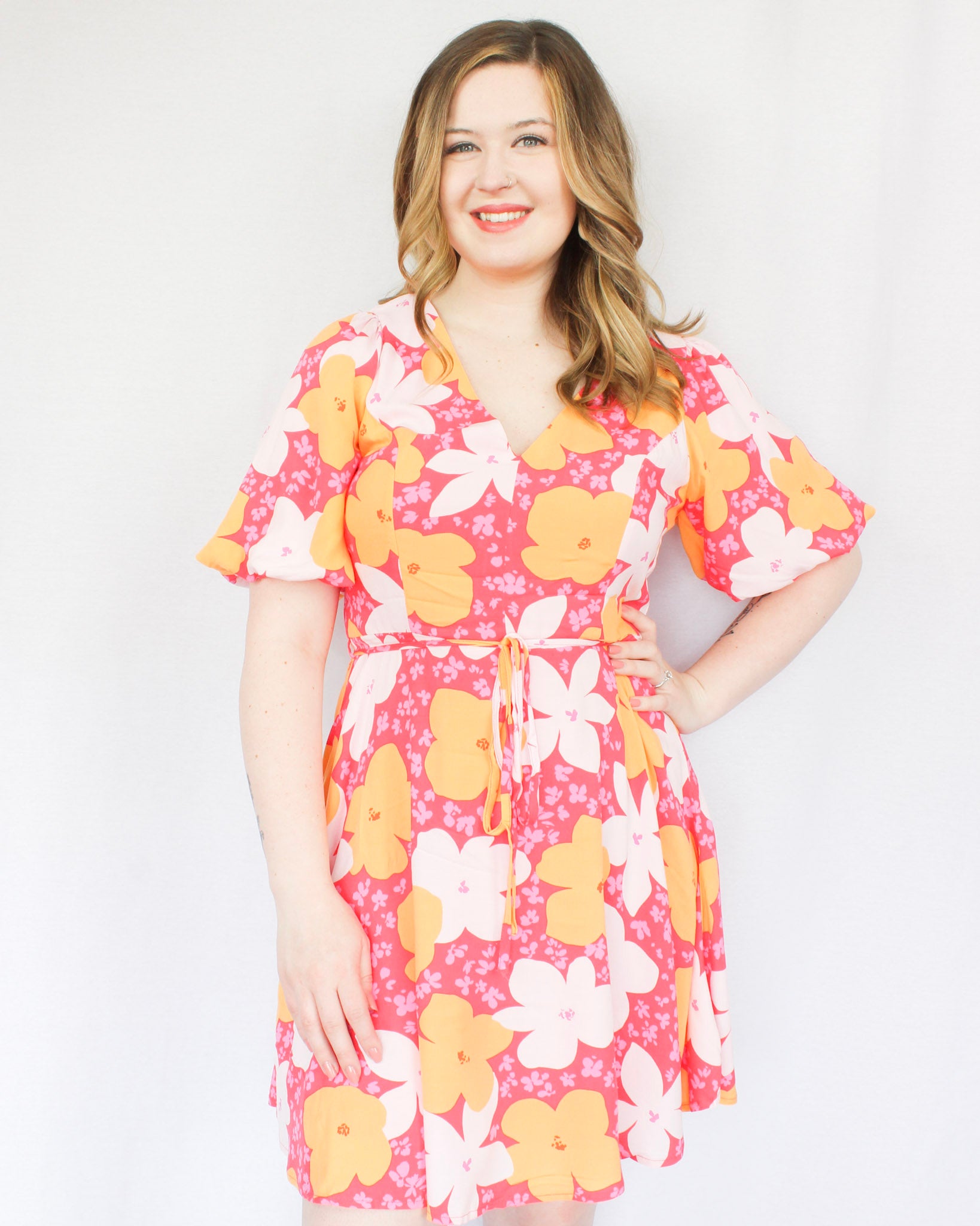 Bright hot pink mini dress with big white, orange, mini pink flowers V neckline flowy skirt puff sleeves and waist tie