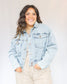 Slightly cropped light wash stretchy denim jacket with two chest pockets and two hand pockets, silver buttons